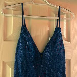 Beautiful blue shimmer dress,mid thigh slit on the left leg zipper on side.